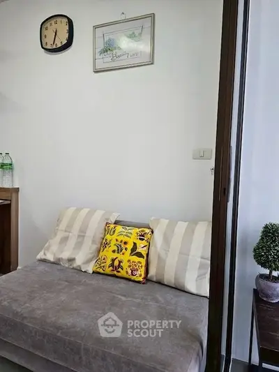 Cozy living room corner with stylish decor and comfortable seating.