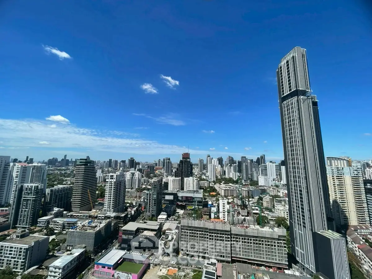 Stunning cityscape view with modern skyscrapers under a clear blue sky, showcasing urban living at its finest.