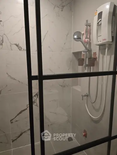 Modern bathroom with marble tiles and sleek shower enclosure