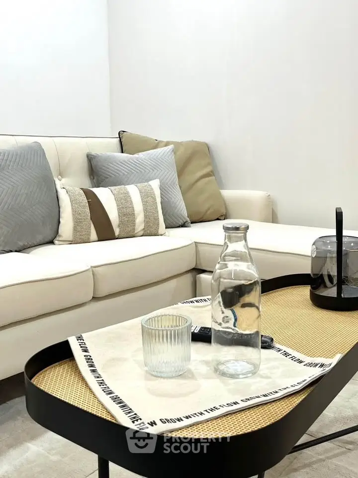 Stylish modern living room with cozy sofa and elegant coffee table setup.