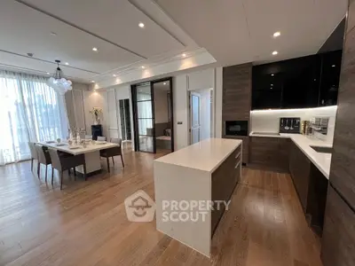 Luxurious open-plan kitchen and dining area with modern design and elegant lighting.