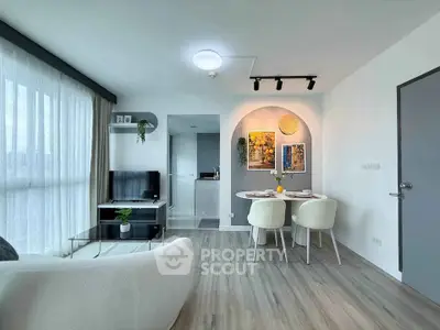 Modern living room with stylish dining area and natural light in contemporary apartment.