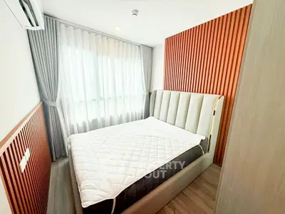 Modern bedroom with stylish wood paneling and natural light