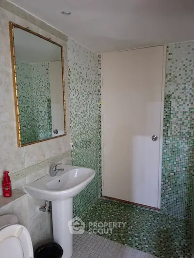 Modern bathroom with mosaic tiles and sleek fixtures