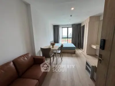 Modern studio apartment with cozy living area and city view
