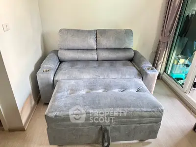 Cozy gray sofa with matching ottoman in a bright living room setting