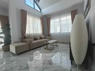 Elegant living room with marble flooring and modern furniture