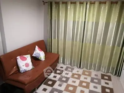 Cozy living room with stylish curtains and modern sofa, perfect for relaxation.