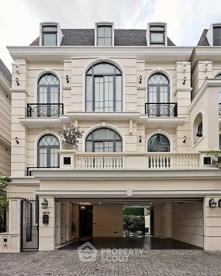 Elegant European-style building facade with arched windows and wrought iron balconies.