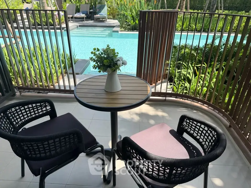 Charming balcony with pool view, perfect for relaxation and leisure.