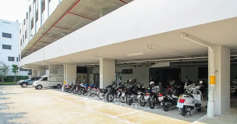 Modern apartment building with spacious motorcycle parking area