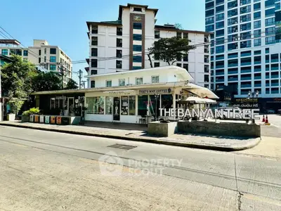 Charming urban street view with modern buildings and cozy coffee shop, ideal for city living.