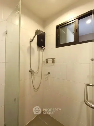 Modern bathroom with glass shower enclosure and sleek fixtures