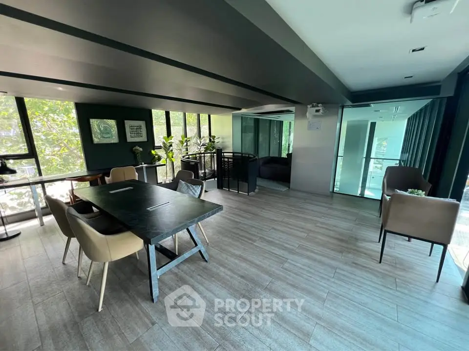 Modern office space with large windows and stylish furniture