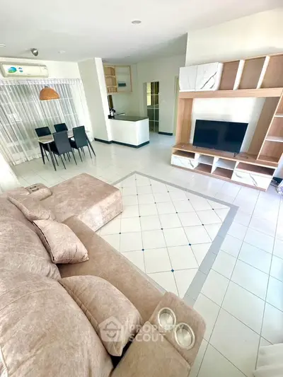 Spacious living room with modern furniture and open layout, perfect for family gatherings.