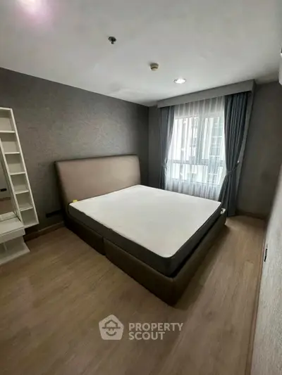 Modern bedroom with large window and stylish decor