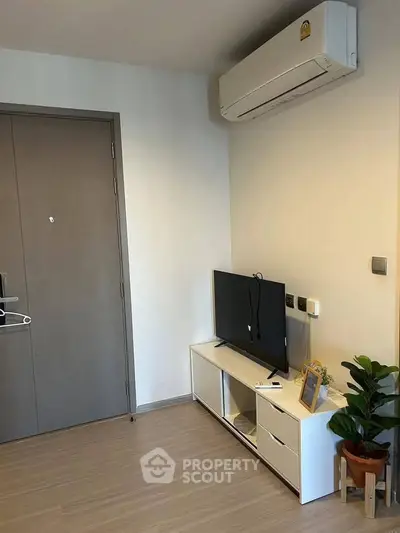 Modern living room with sleek TV unit and air conditioning