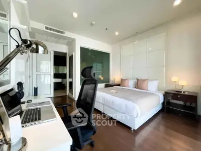 Modern bedroom with study area featuring sleek desk and comfortable chair, perfect for work and relaxation.