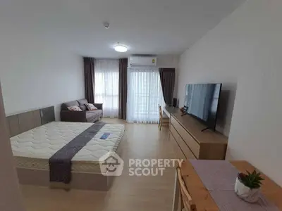 Modern studio apartment with cozy furnishings and natural light