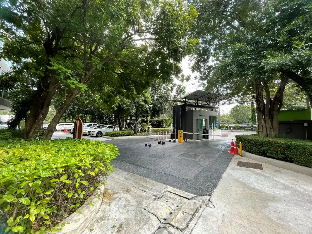 Secure gated entrance with lush greenery and modern design