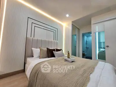 Luxurious bedroom with modern design and ambient lighting, featuring a cozy bed and elegant decor.
