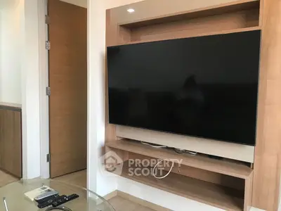 Modern living room with sleek wall-mounted TV and stylish wooden paneling.