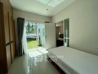 Bright bedroom with garden view and sliding glass doors in modern home