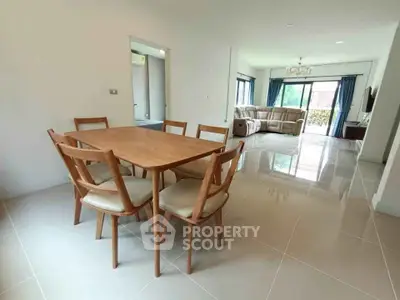 Spacious open-plan living and dining area with modern furniture and natural light.