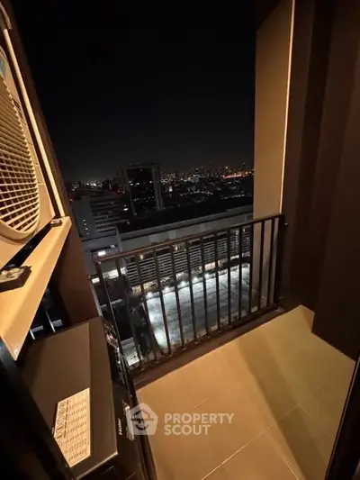 Stunning night city view from a high-rise balcony, perfect for urban living.