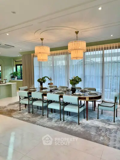 Elegant dining room with luxurious chandelier and large windows