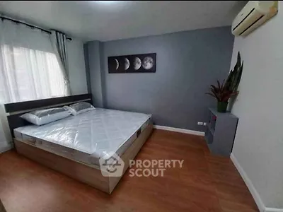 Modern bedroom with stylish decor and air conditioning in a cozy apartment.
