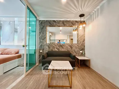 Modern living room with marble accents and stylish lighting in a contemporary apartment.