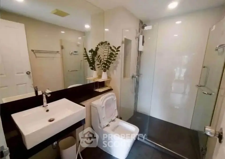 Modern bathroom with sleek fixtures and glass shower enclosure