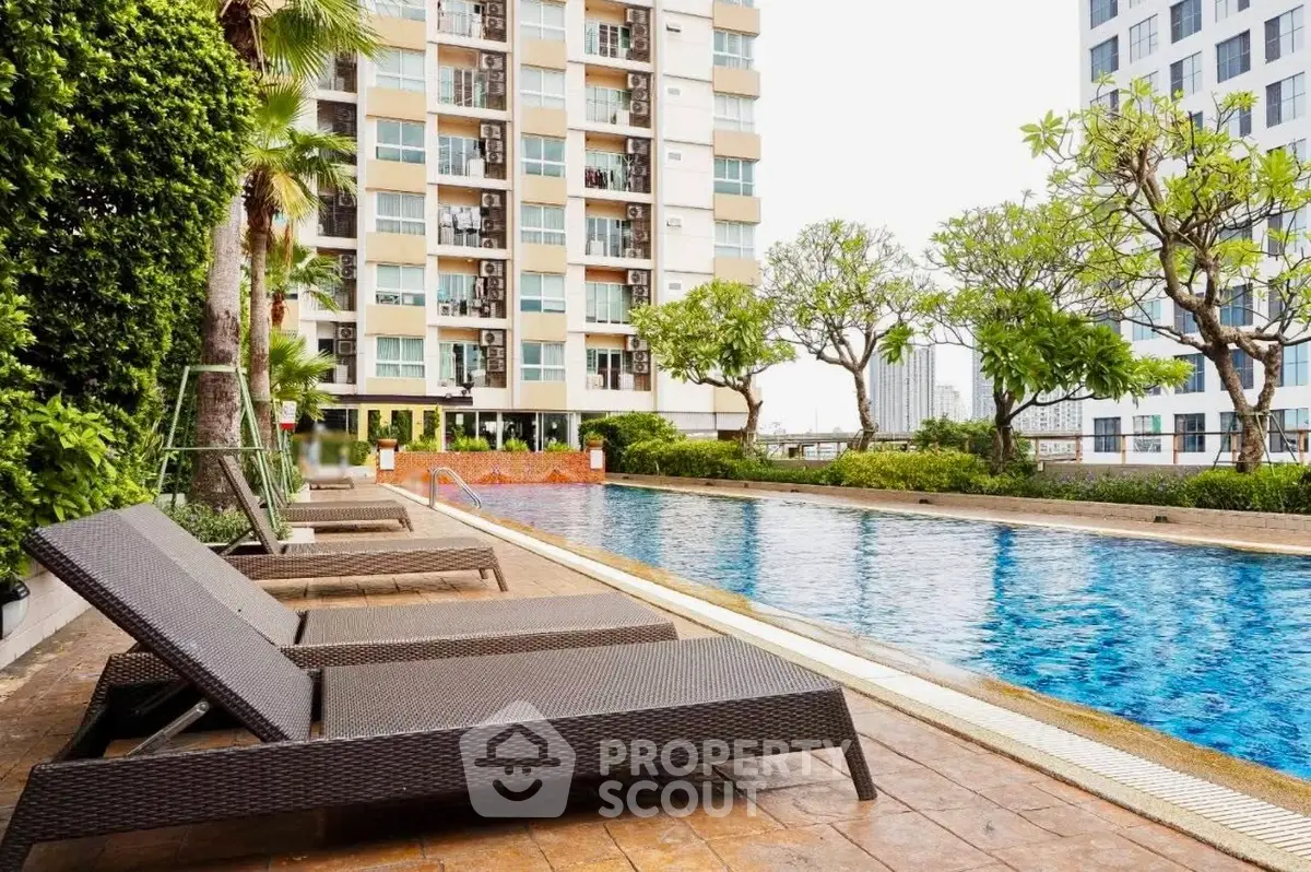 Luxurious apartment complex with a stunning outdoor pool and lush greenery, perfect for relaxation and leisure.