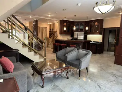 Luxurious open-plan living room with elegant staircase and modern kitchen