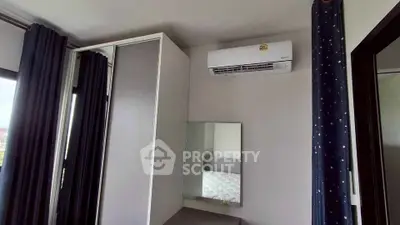 Modern bedroom with air conditioning and stylish curtains