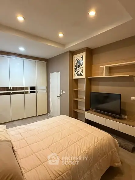 Modern bedroom with built-in wardrobe and cozy lighting