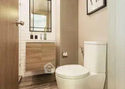 Modern bathroom with sleek fixtures and stylish wood accents.