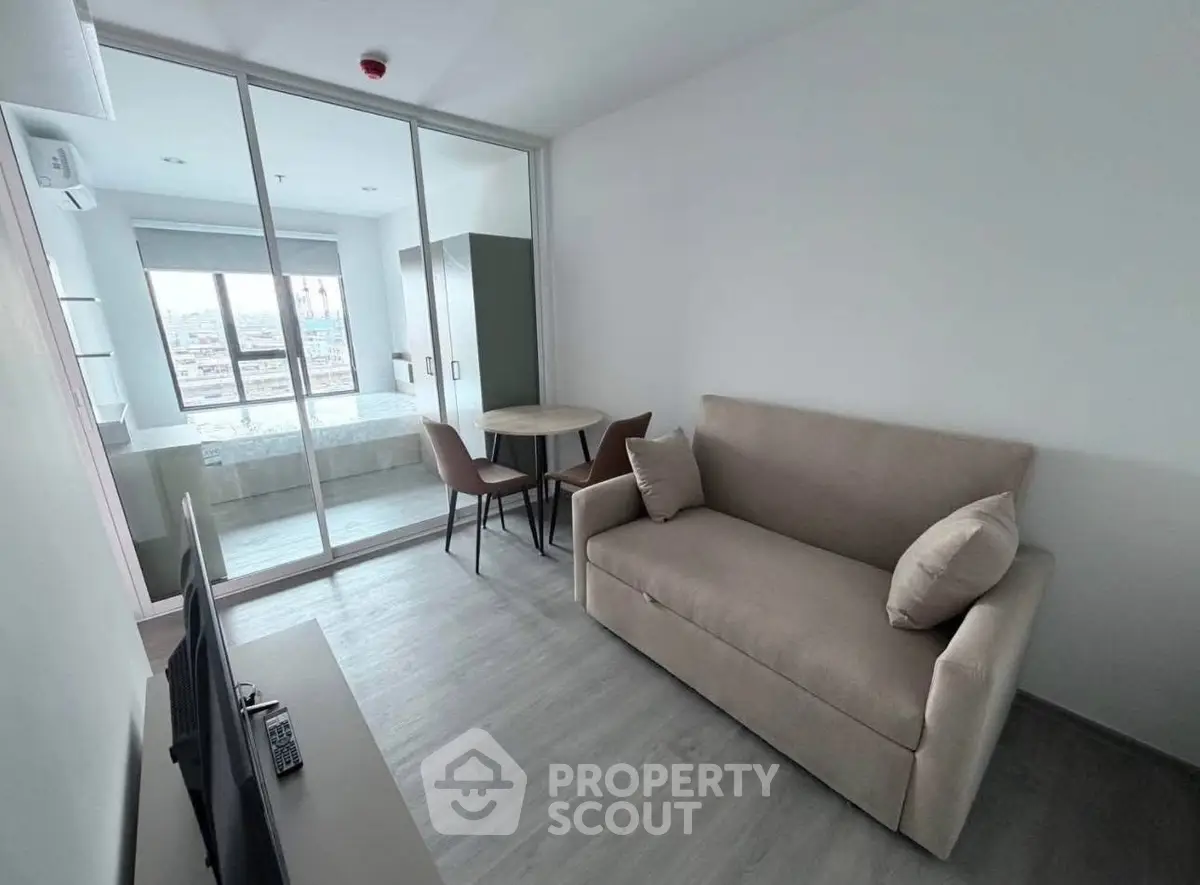 Modern studio apartment with cozy living area and city view