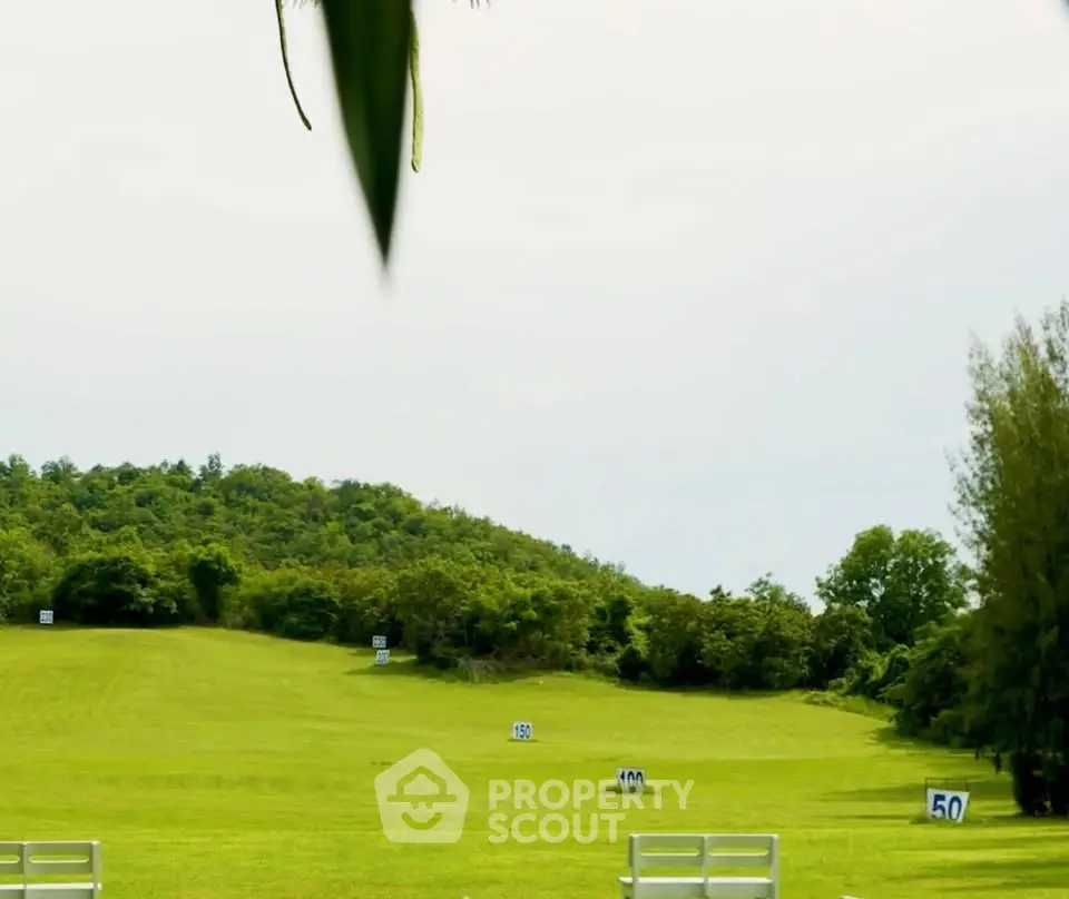 Expansive green landscape with numbered markers, ideal for outdoor activities and development.