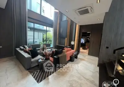Luxurious modern living room with high ceilings and large windows