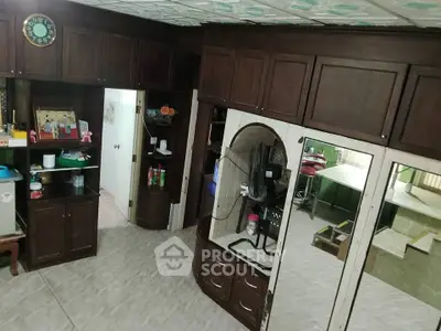 Spacious living room with dark wood cabinetry and tiled flooring