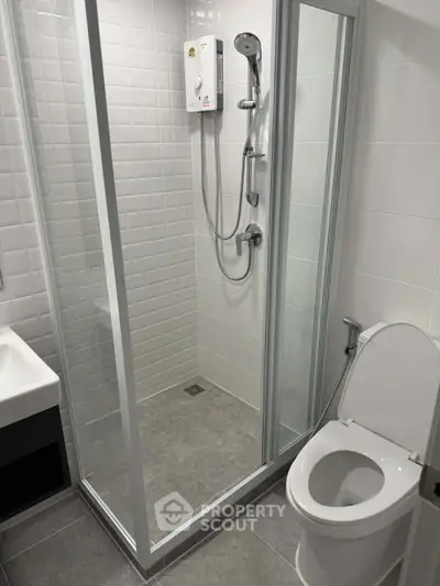 Modern bathroom with glass shower enclosure and sleek fixtures