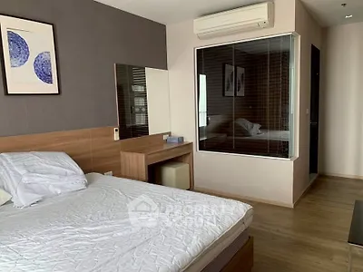 Modern bedroom with wooden flooring and stylish decor