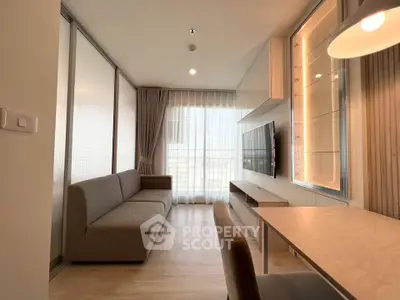 Modern living room with sleek furniture and large window for natural light.