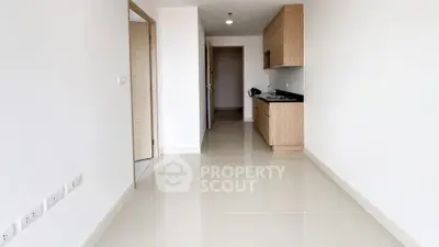 Spacious modern apartment with sleek kitchen and glossy tiled floors, perfect for contemporary living.