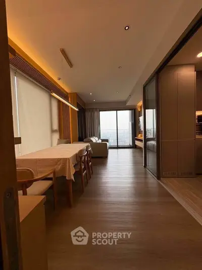 Spacious modern living room with dining area and large windows offering a stunning view.
