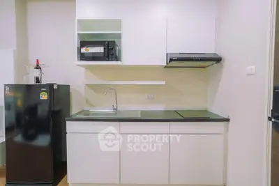 Modern kitchen with sleek white cabinets and appliances, perfect for urban living.