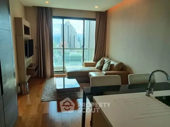 Modern living room with city view, featuring sleek furniture and open layout.