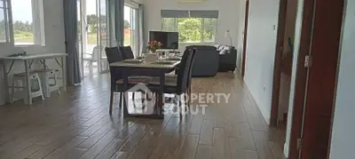 Spacious open-plan living and dining area with natural light and modern decor.